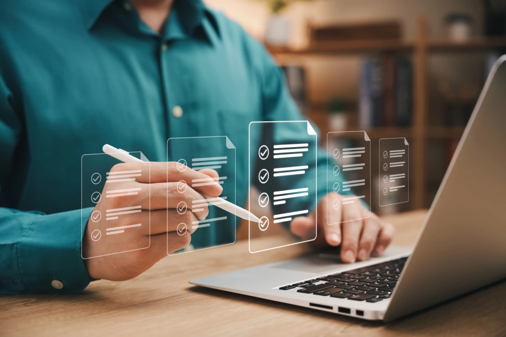 Man with stylus completing a digital checklist on a computer.